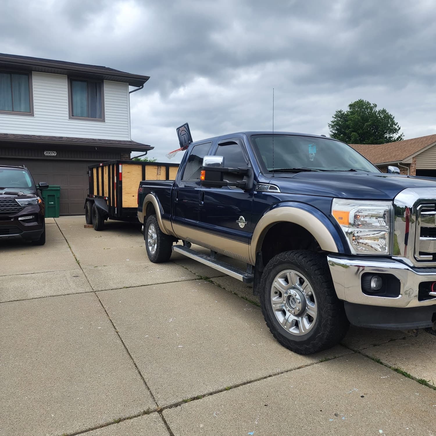 Roll-off dump trailer delivered to a residential driveway in Southeast Michigan
