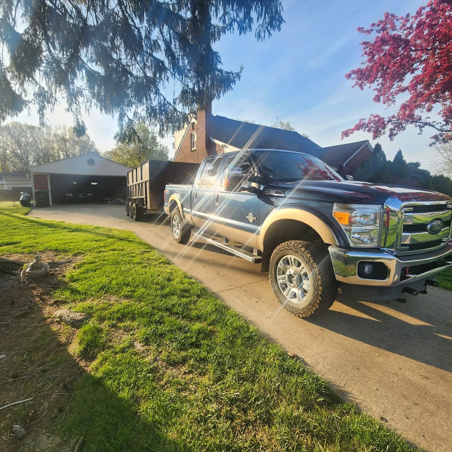 Dump trailer parked in a Downriver residential driveway for a home cleanout